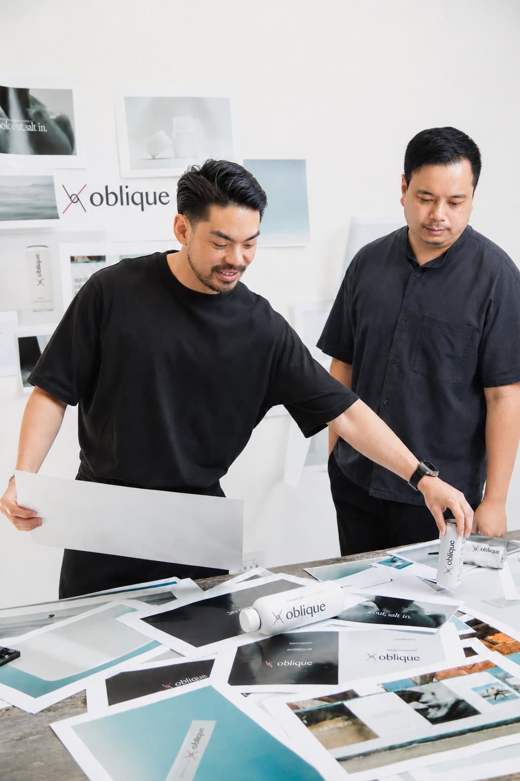 Sean Ng and Jun Yew Kong, Co-Founders of Oblique, reviewing brand work in the studio